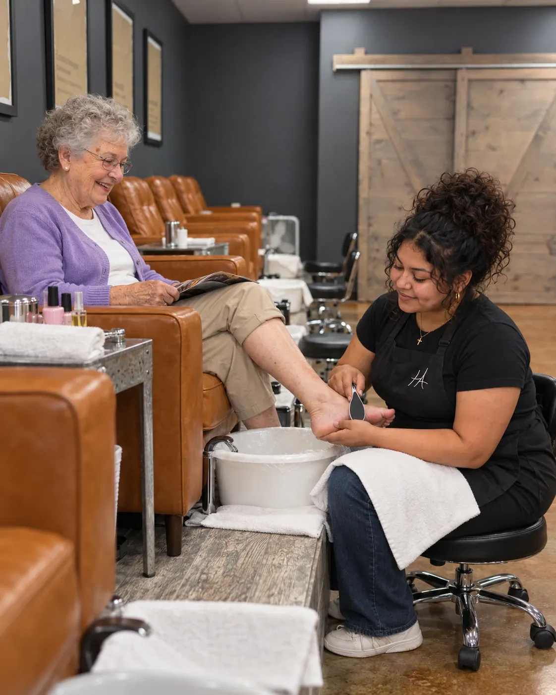 Nail technology student giving a pedicure in the Hays pedicure room